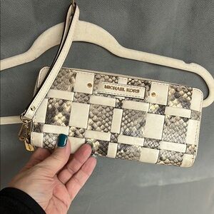 Michael Kors Snakeskin Woven Wristlet. Measures 8.5” x 4.5”.